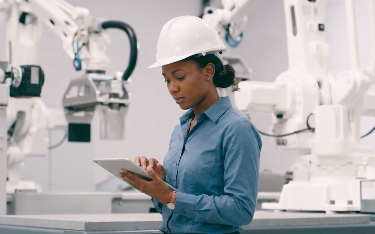Engineer using a tablet in an automated factory